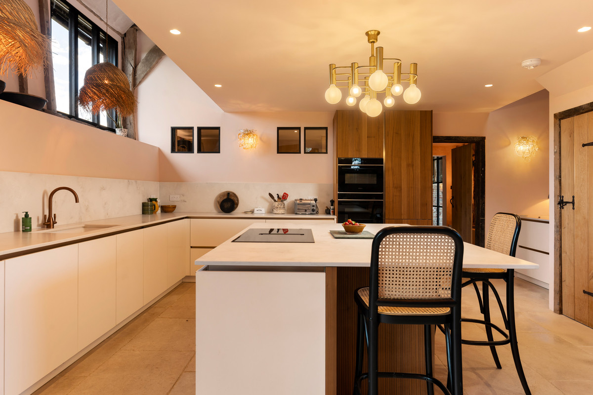 Barn Owl kitchen with white cabinetry, walnut detailing, exposed timbers and pendant lighting