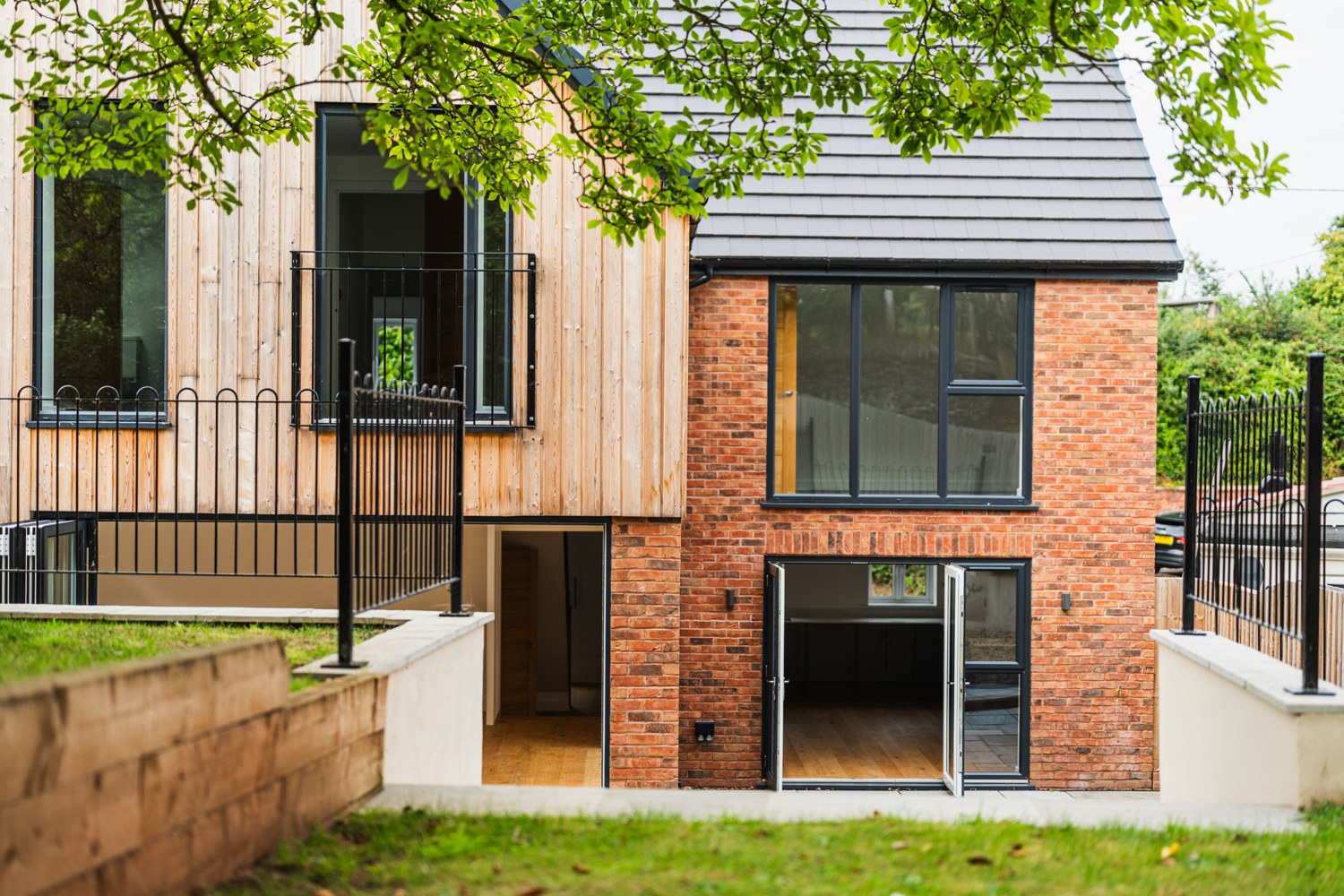 Contemporary home with timber cladding and red brick detailing