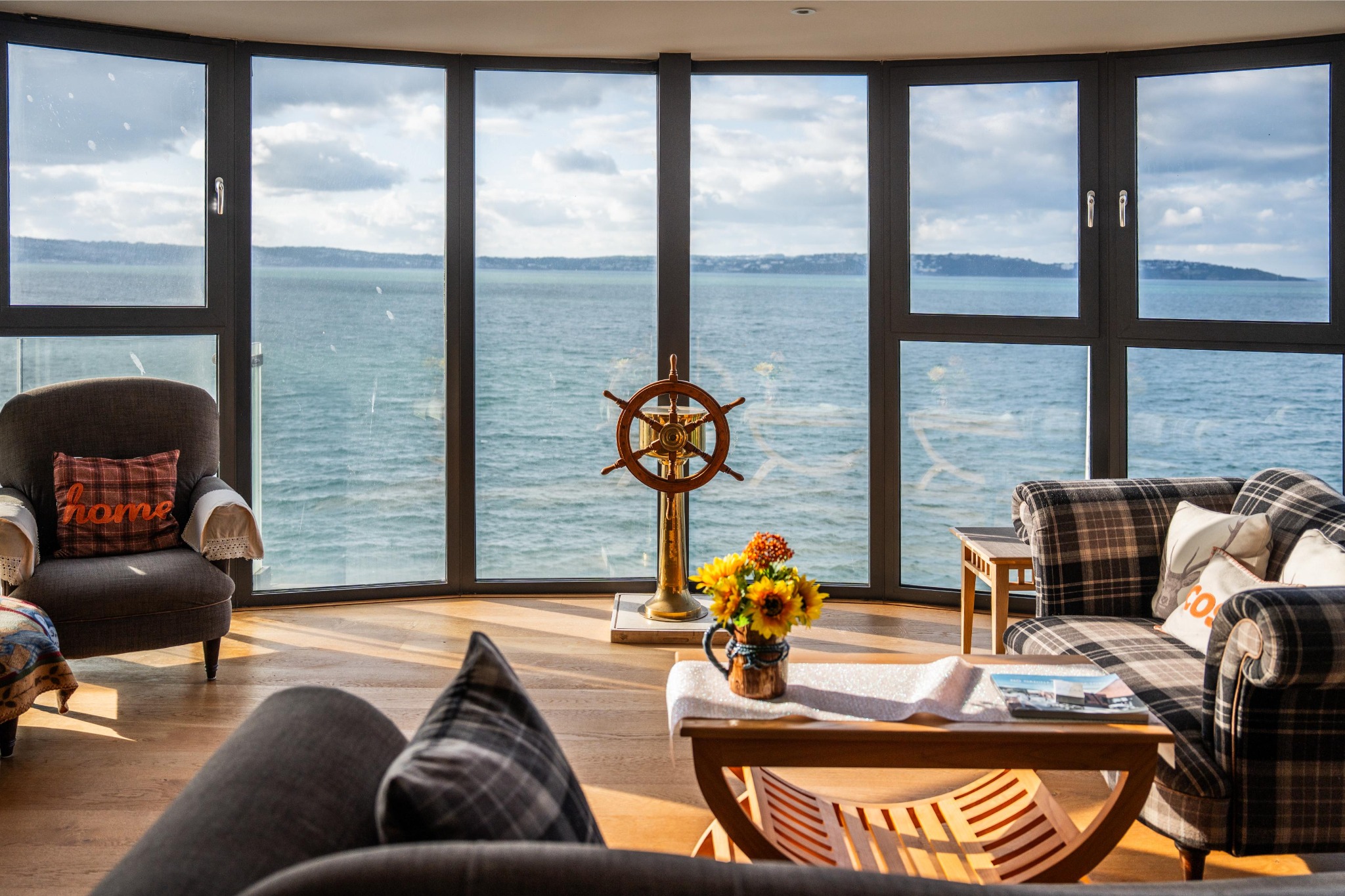 Seating area looking across Tor Bay through curved glazing